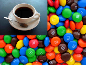 A picture of loose M&Ms of various colours with a picture of a cup of coffee overlayed